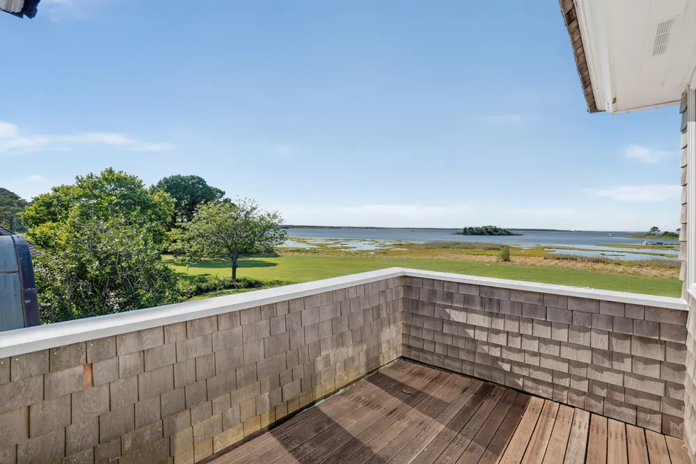 The view from an upper deck across the lawn to the bay