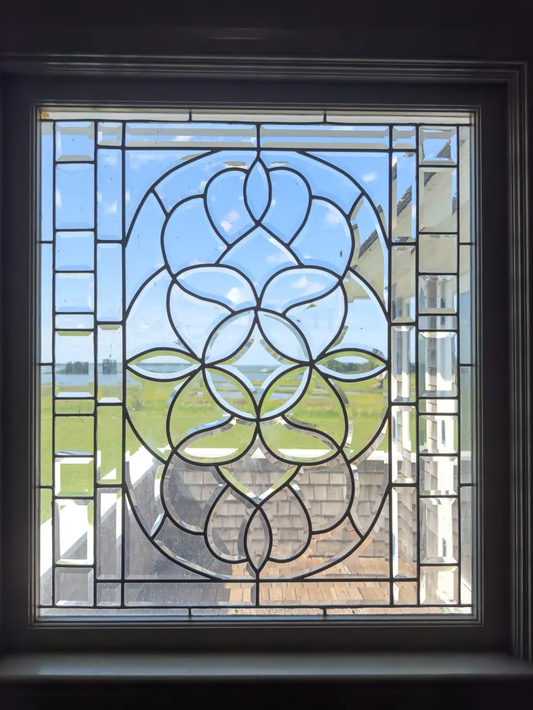 A leaded-glass window looking out to the water