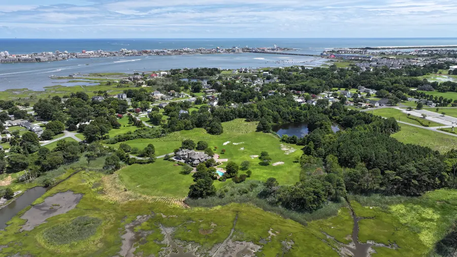 Aerial view of the estate set between the marsh and a pond, with Ocean City across the bay